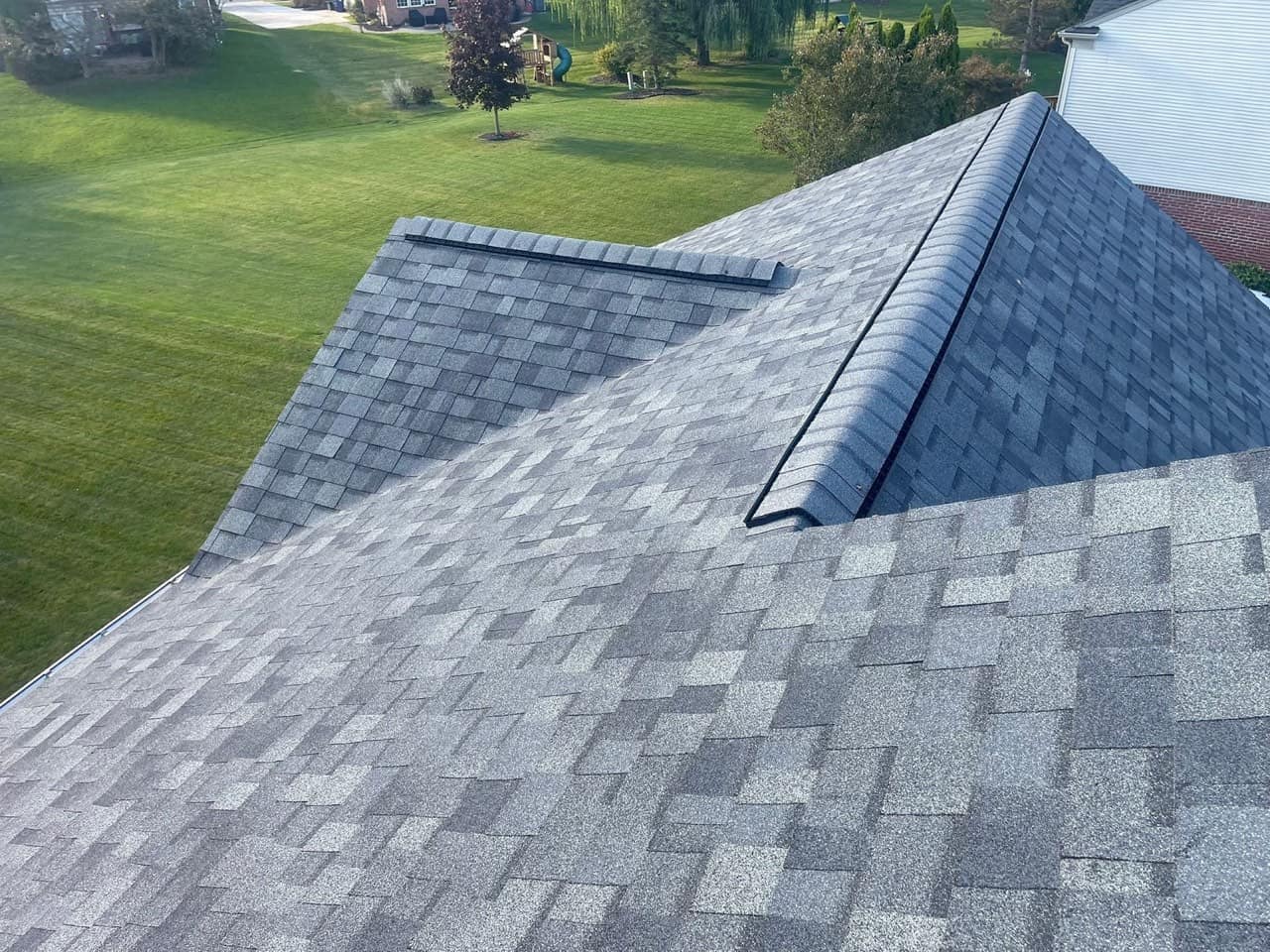 Close-up of new architectural shingles with crisp ridge and hip lines