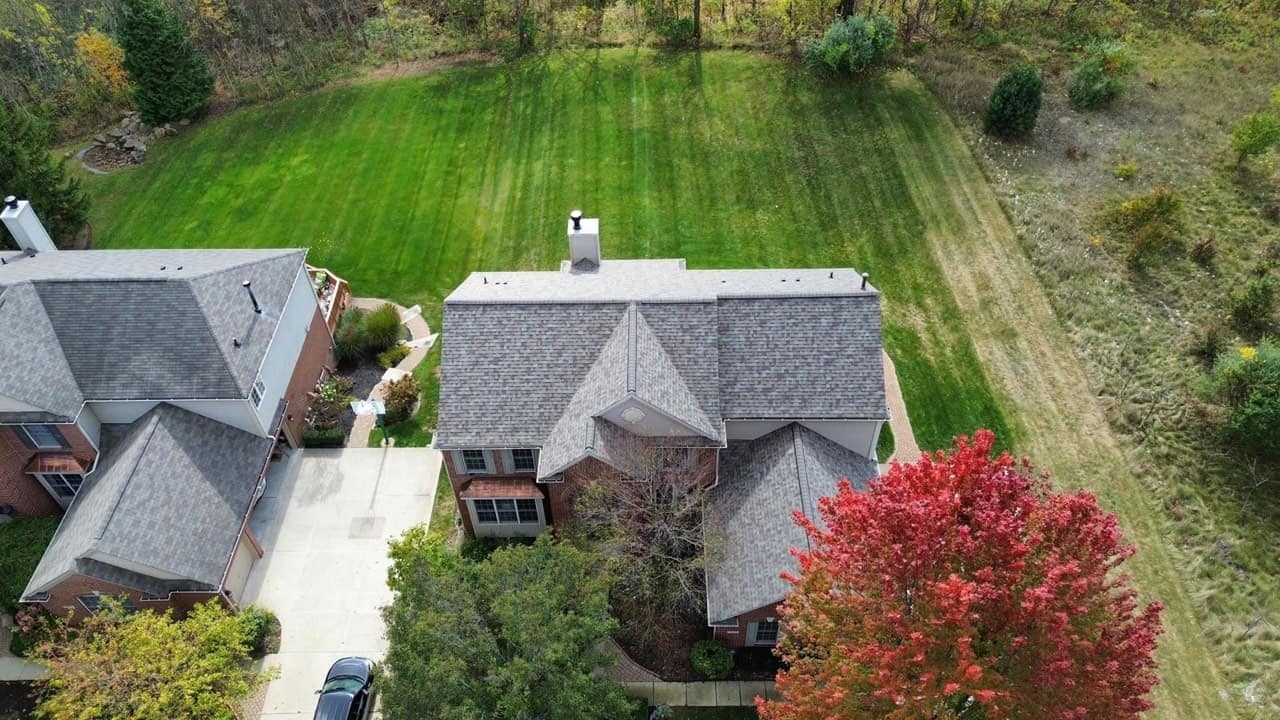 Metro Detroit home under fall tree cover — where gutter guards earn their keep