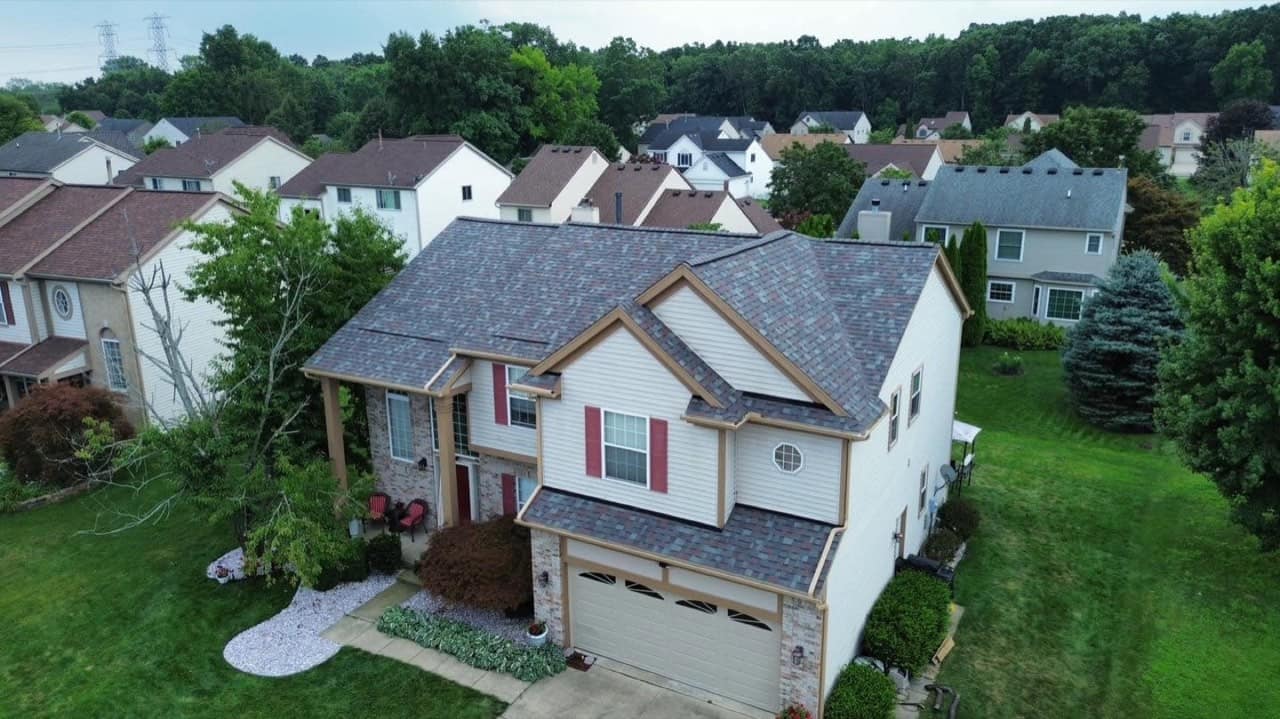 Two-story metro Detroit home with a new architectural shingle roof by Guthix Roofing